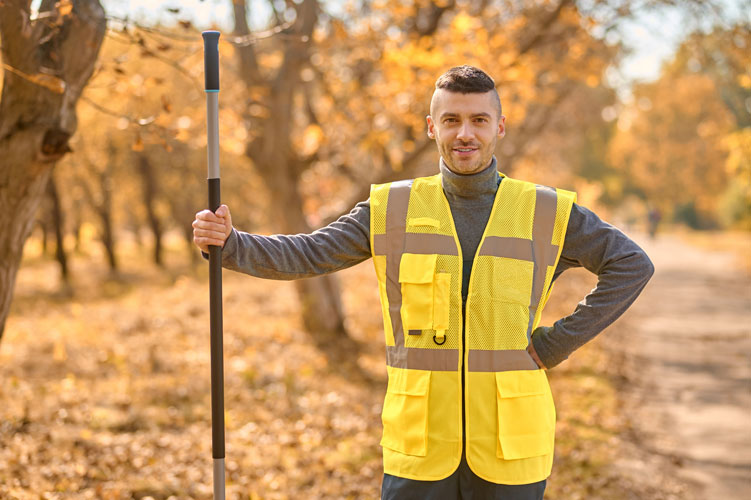a man wearing his yellow vest at work